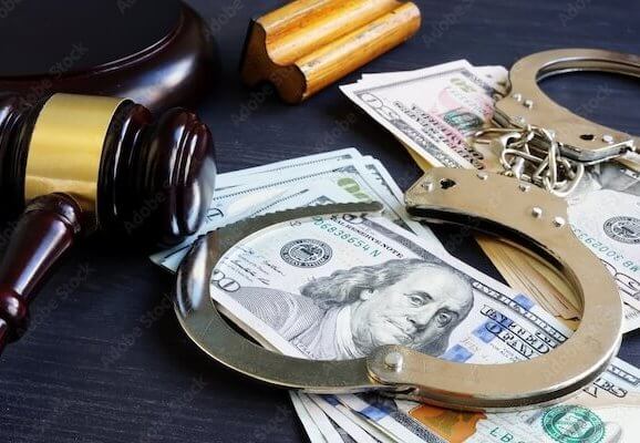 Handcuffs sitting on top of money. Symbolizing bail bonds